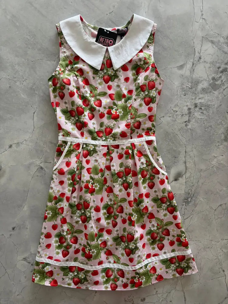 Retro strawberry print sleeveless cotton a-line dress with white peter pan collar and waistband on light pink background