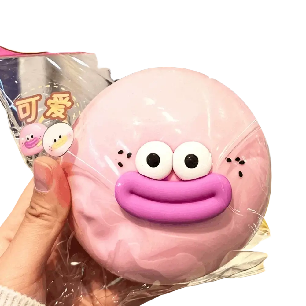 Pink round plush stress relief toy duck with large white eyes smiling mouth slow rising compress toy