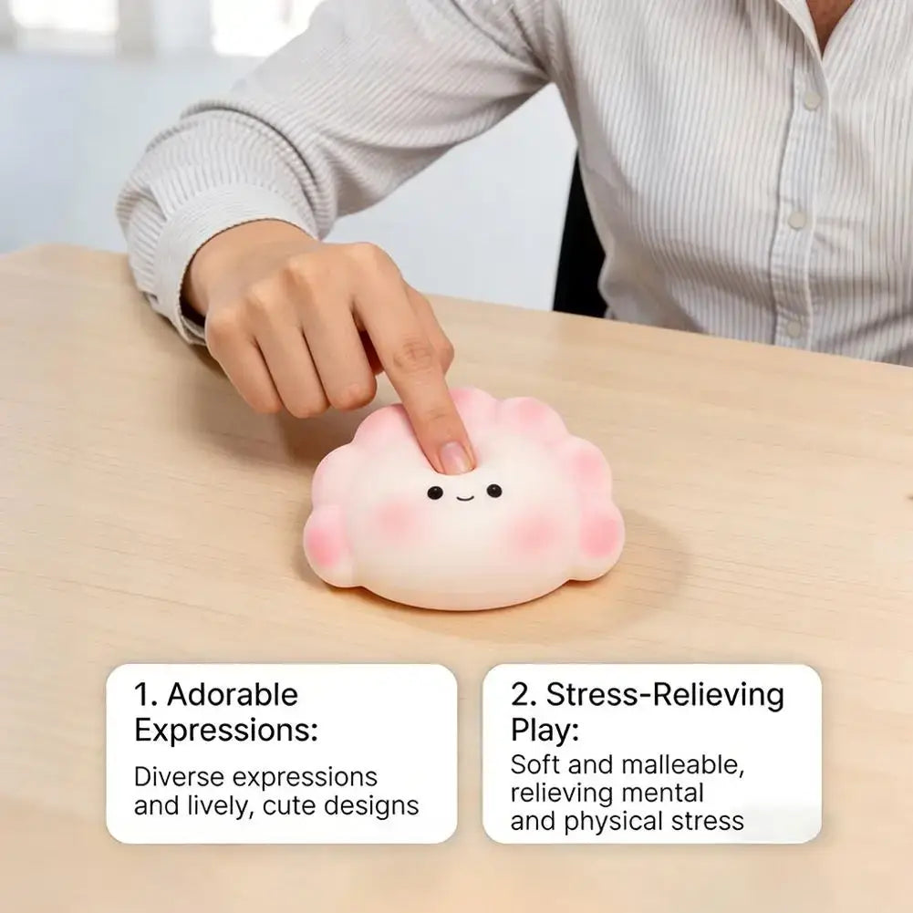 Pink soft malleable dumpling squishy stress-relieving toy with cute cloud shape and simple black dot eyes for fidgeting