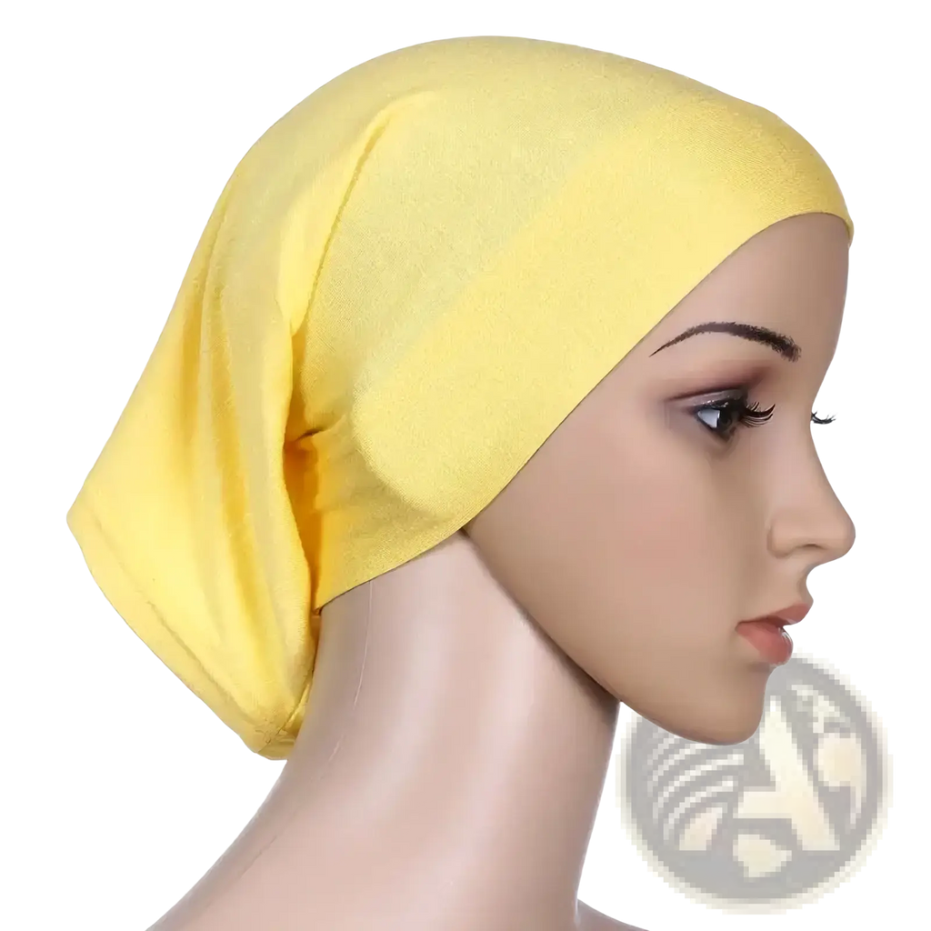 A soft solid yellow stretchy hijab underscarf cap made of smooth fabric draped gently on a mannequin head