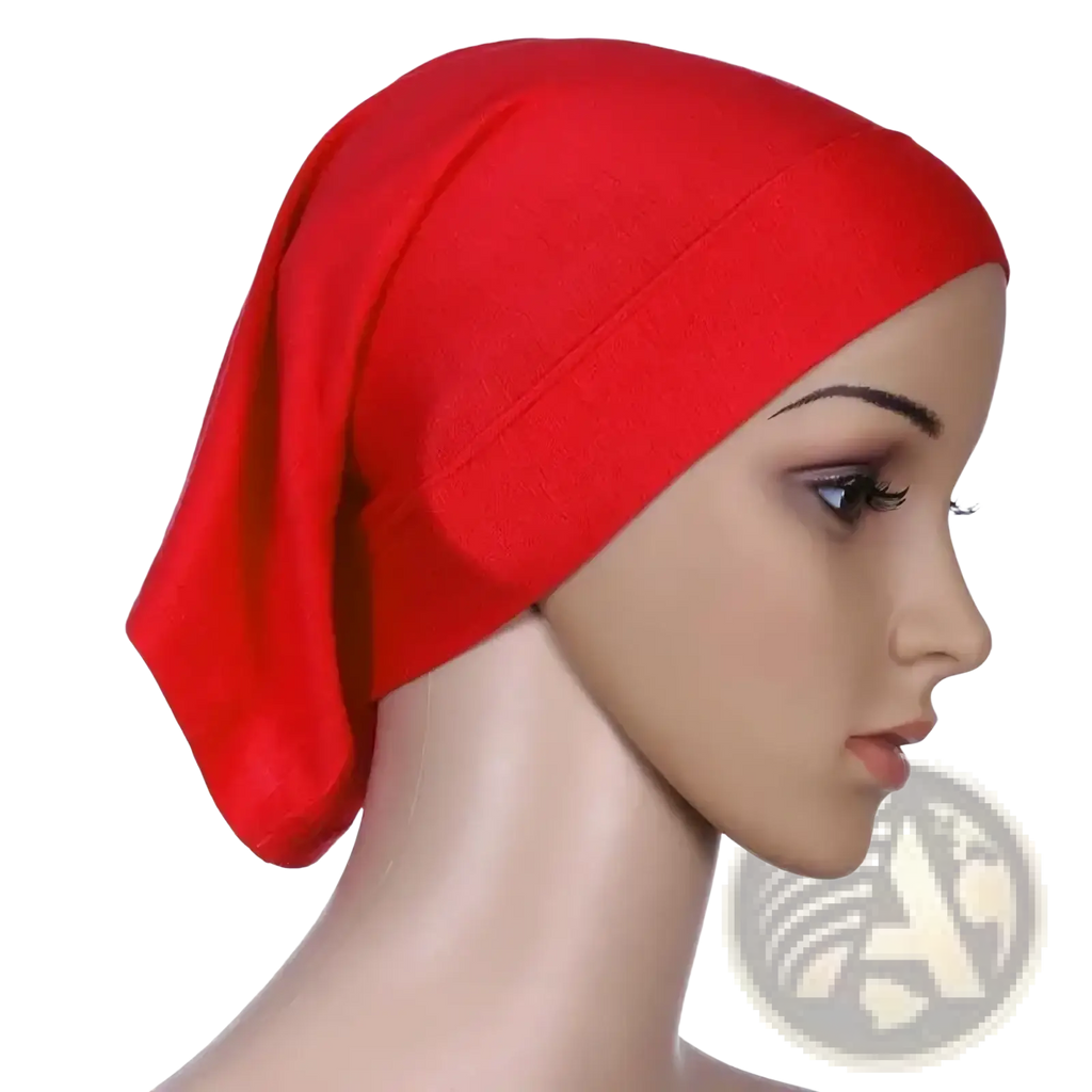 A vibrant red stretchy hijab underscarf cap with soft texture worn snugly on a mannequin’s head for women