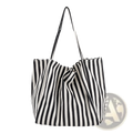 Black and white vertically striped high capacity canvas tote bag with matching shoulder straps for everyday use