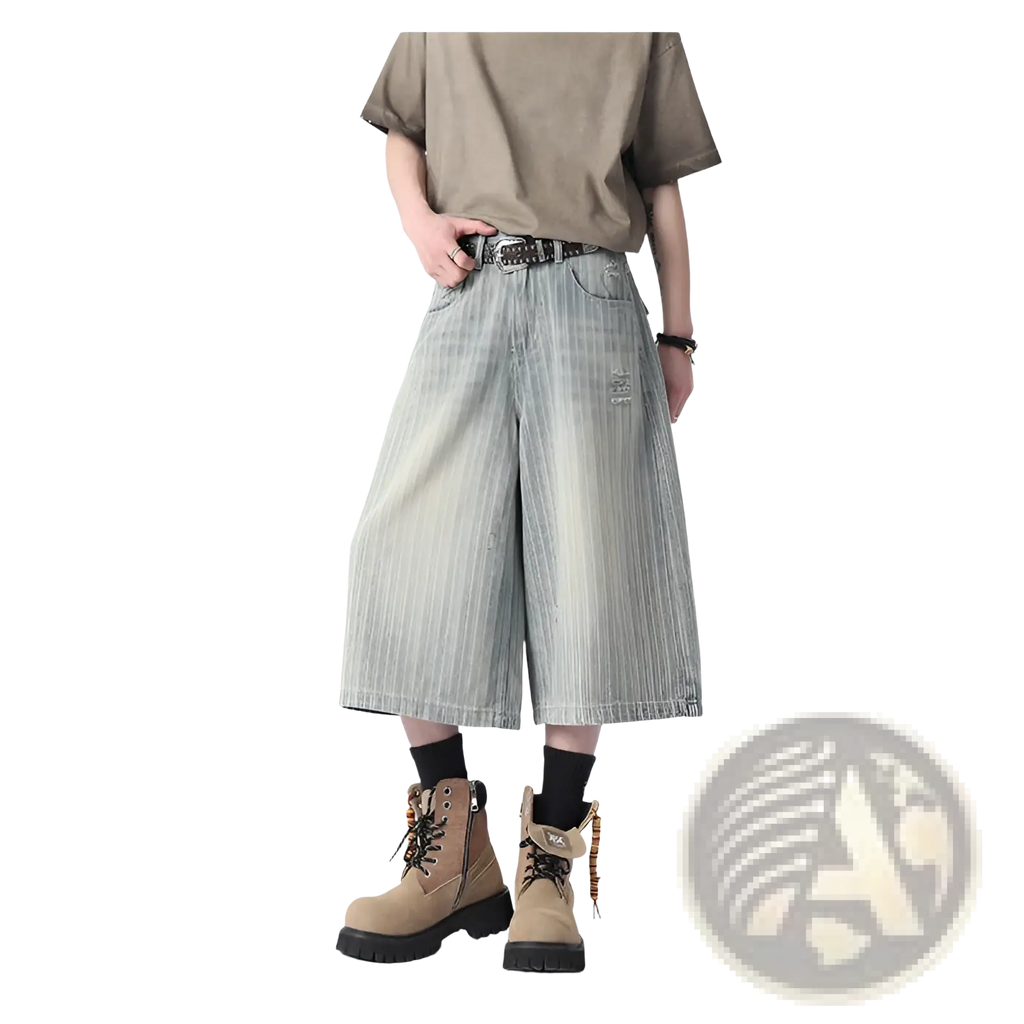Light-wash denim striped capri shorts with wide legs and a distressed patch on the thigh