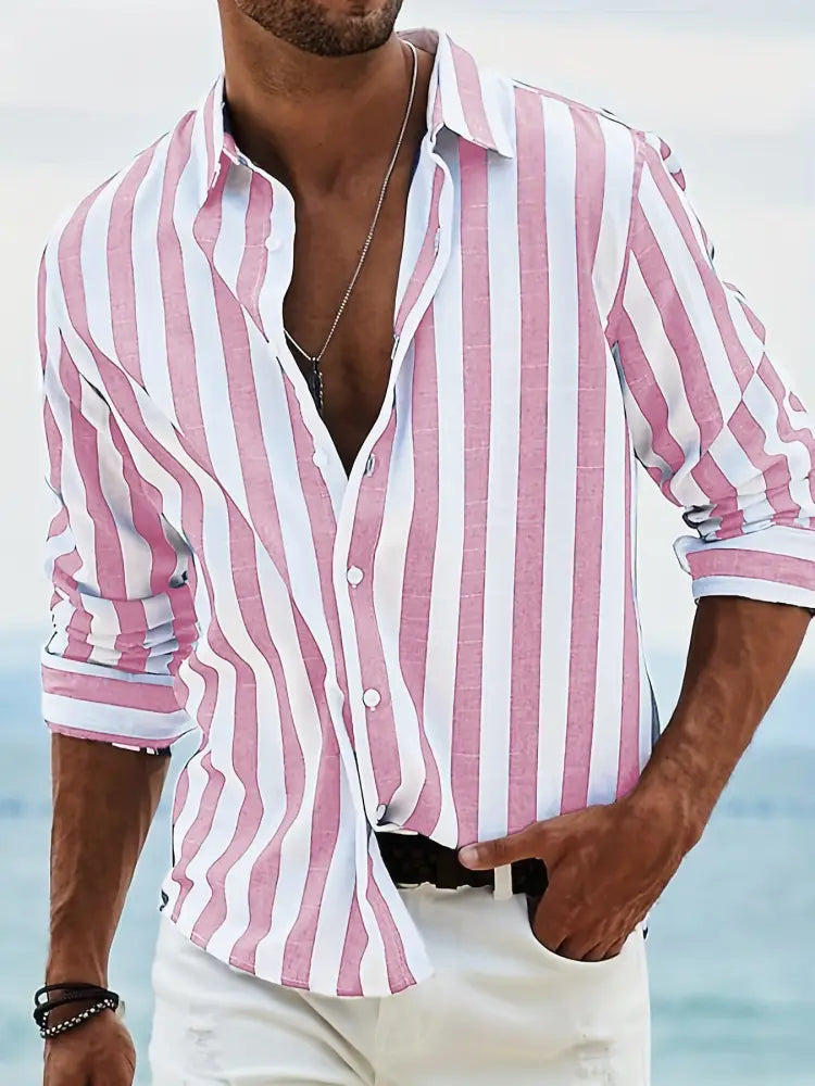 A man wearing a men’s loose fit vertical striped pink and white long sleeve casual button-down shirt with rolled sleeves
