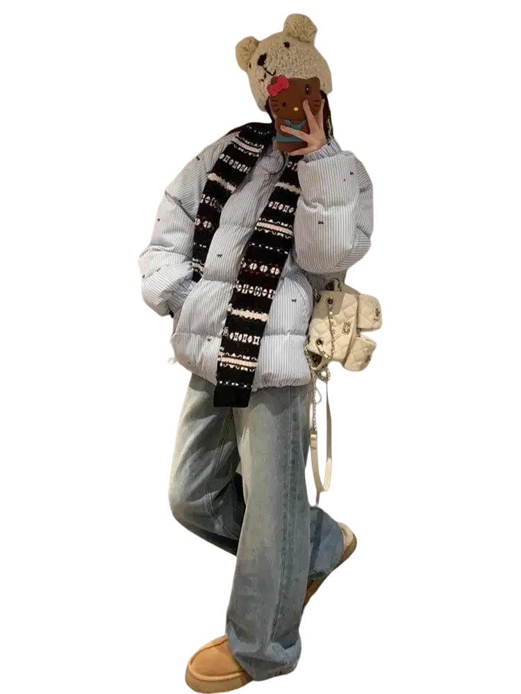 White quilted crossbody bag with chain strap and decorative studs paired with striped puffer jacket winter coat