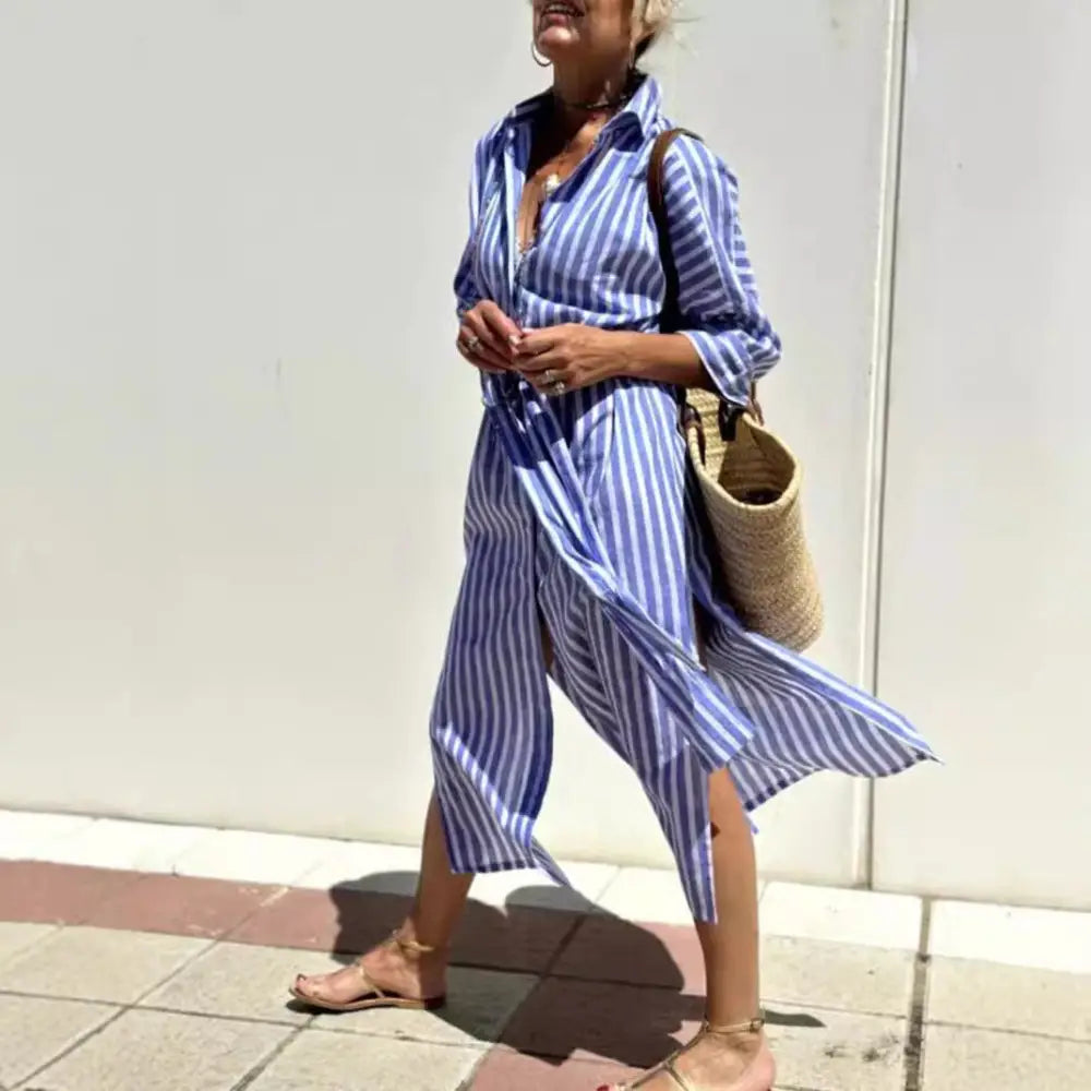 Blue and white vertically striped cotton shirt dress with button-up front side slit and rolled sleeves