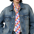 A vibrant polka dot striped silk neck scarf for women featuring red blue purple and pink circles on white background
