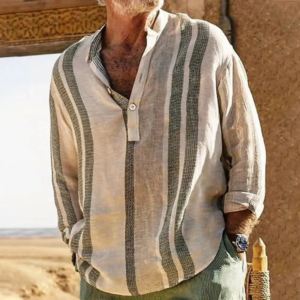 A man wearing a men’s striped slub linen casual shirt in light beige and dark green with rolled-up sleeves