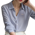 Light blue and white striped synthetic fiber women shirt with long sleeves and embroidered logo on left chest