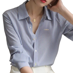 Light blue and white striped synthetic fiber women shirt with long sleeves and embroidered logo on left chest