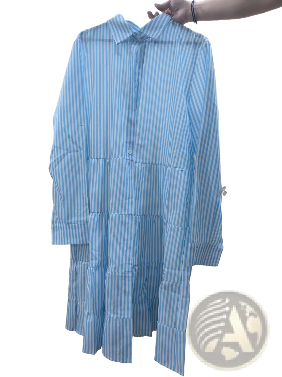 A light blue and white striped tiered ruffle shirt dress with lapel collar and button front in cotton fabric