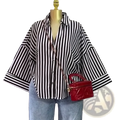 Red quilted leather handbag with gold-tone hardware and chain strap paired with striped Y2k button up blouse