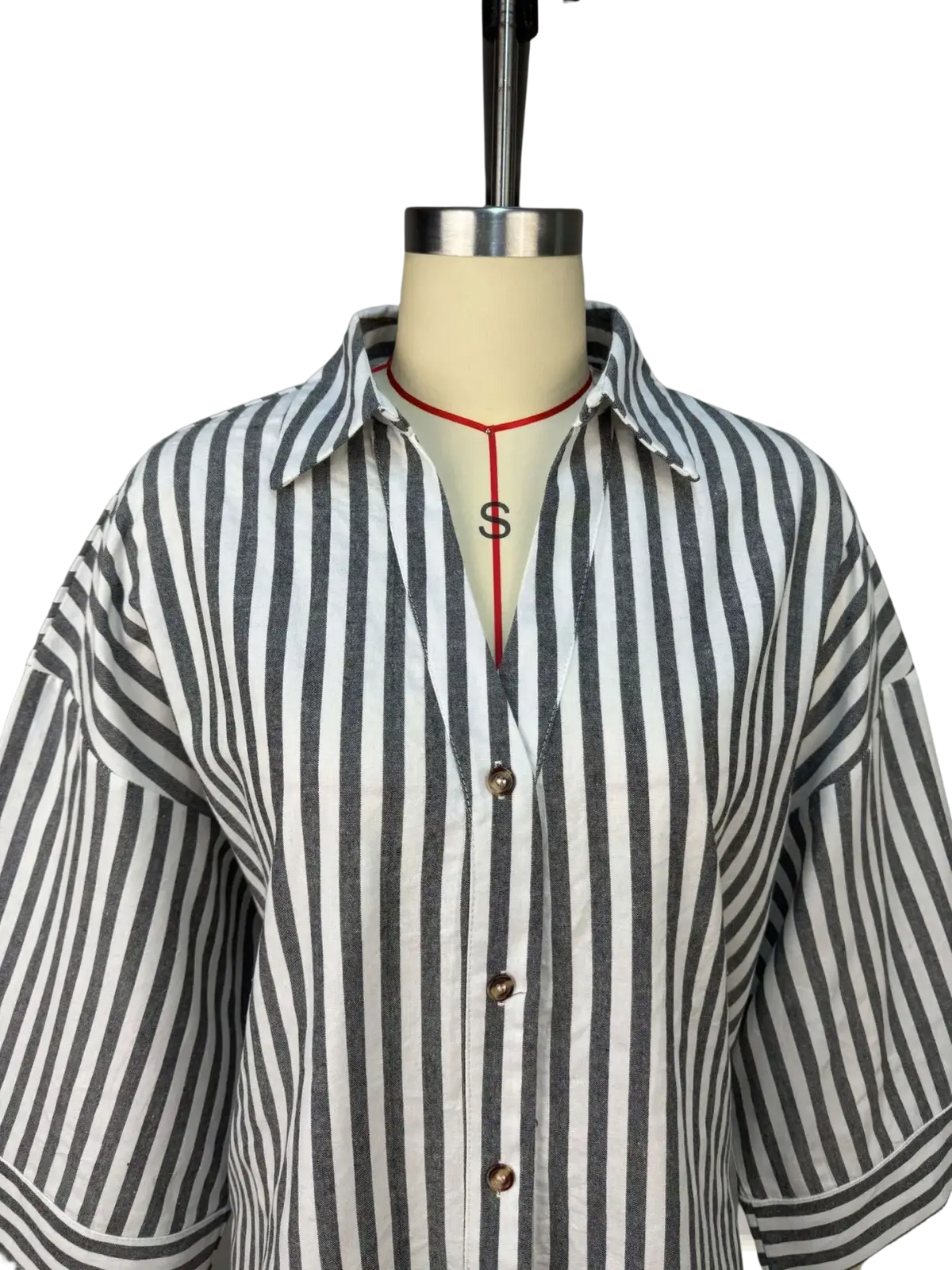 Women’s short-sleeved button-up blouse with vertical black and white stripes featuring matching collar and cuffs