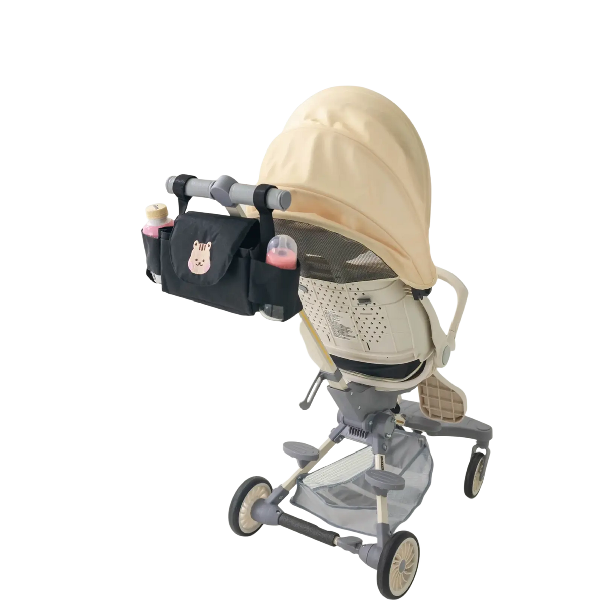 Black stroller organizer bag with bear design featuring a pink bunny face patch holding two baby bottles