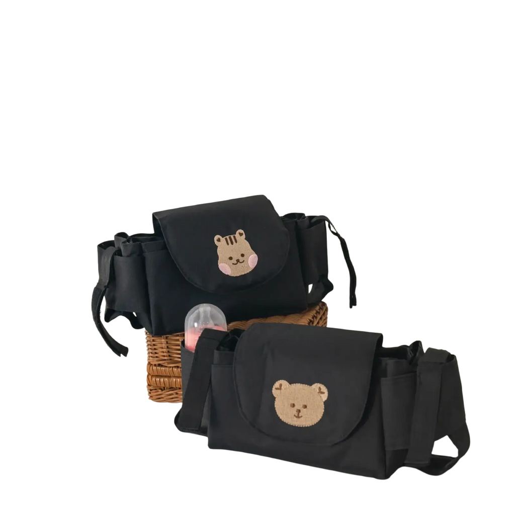 Black baby changing bag with embroidered bear face design shown from the back in stroller organizer bag style