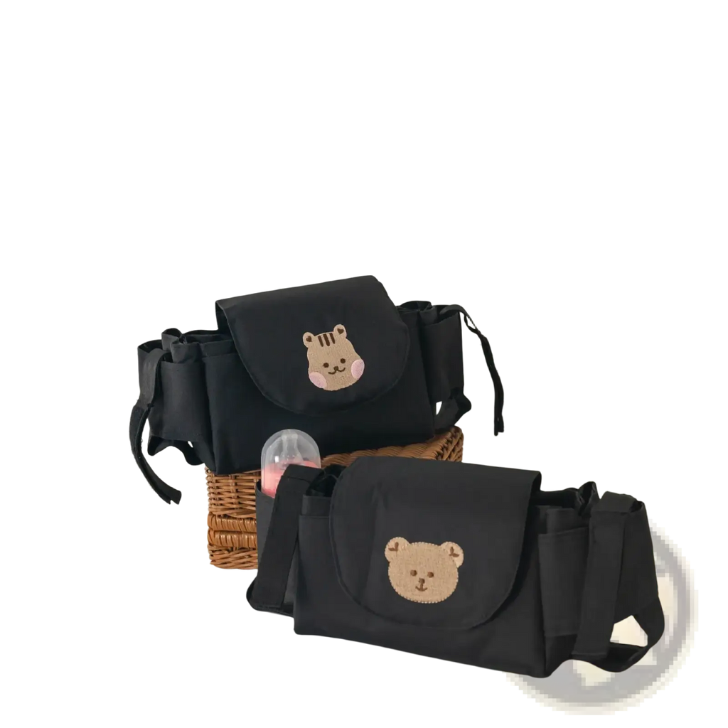 Black baby changing bag with embroidered bear face design shown from the back in stroller organizer bag style