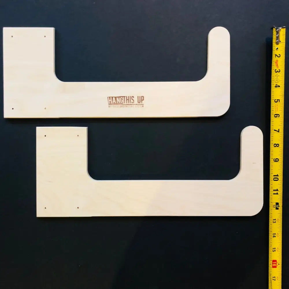 White wooden u-shaped stud mounted wall hooks with hang it up branding for shed storage organization