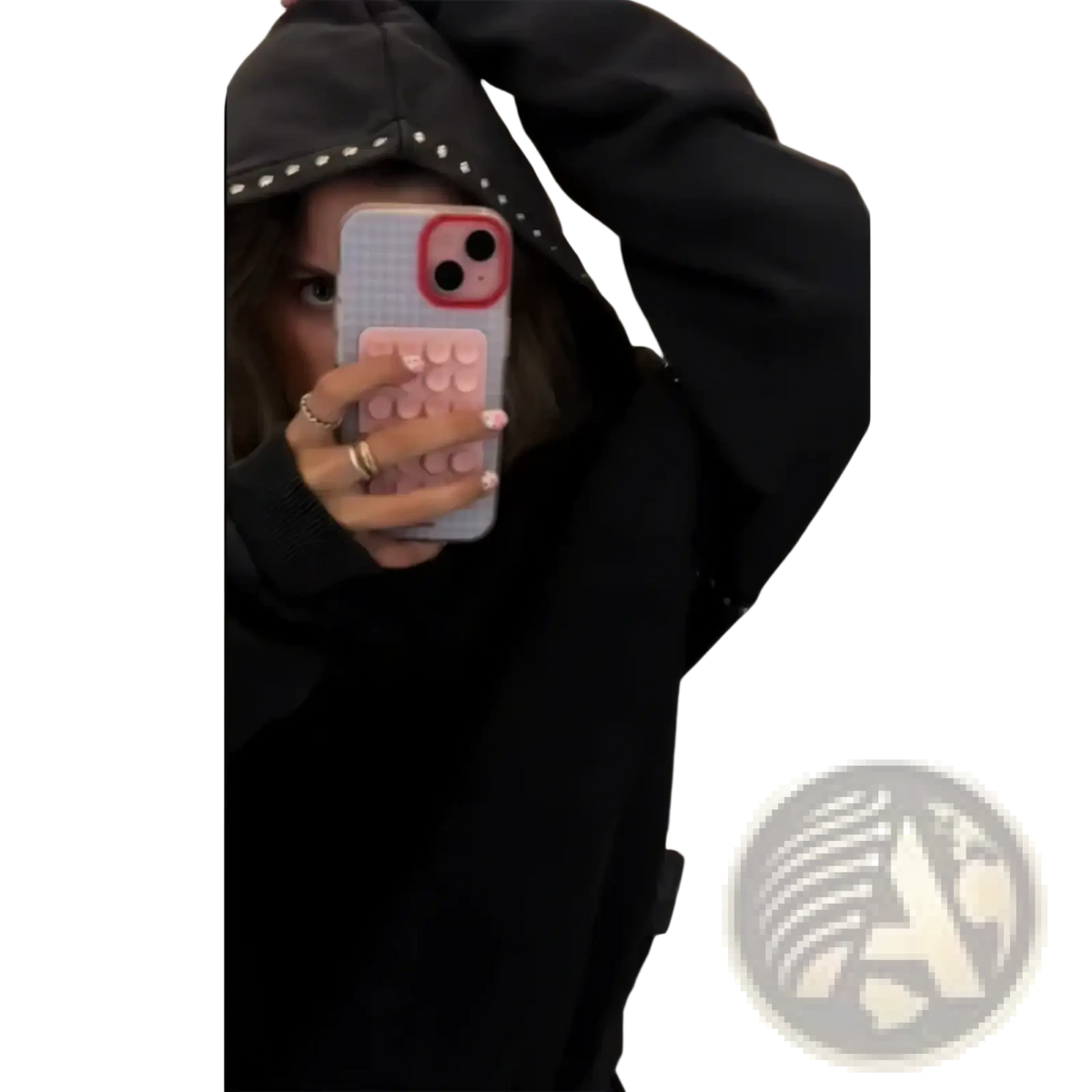 Studied black hoodie loose casual women sweatshirt shown with a light gray phone case with pink pop socket and red camera cutout on the back side