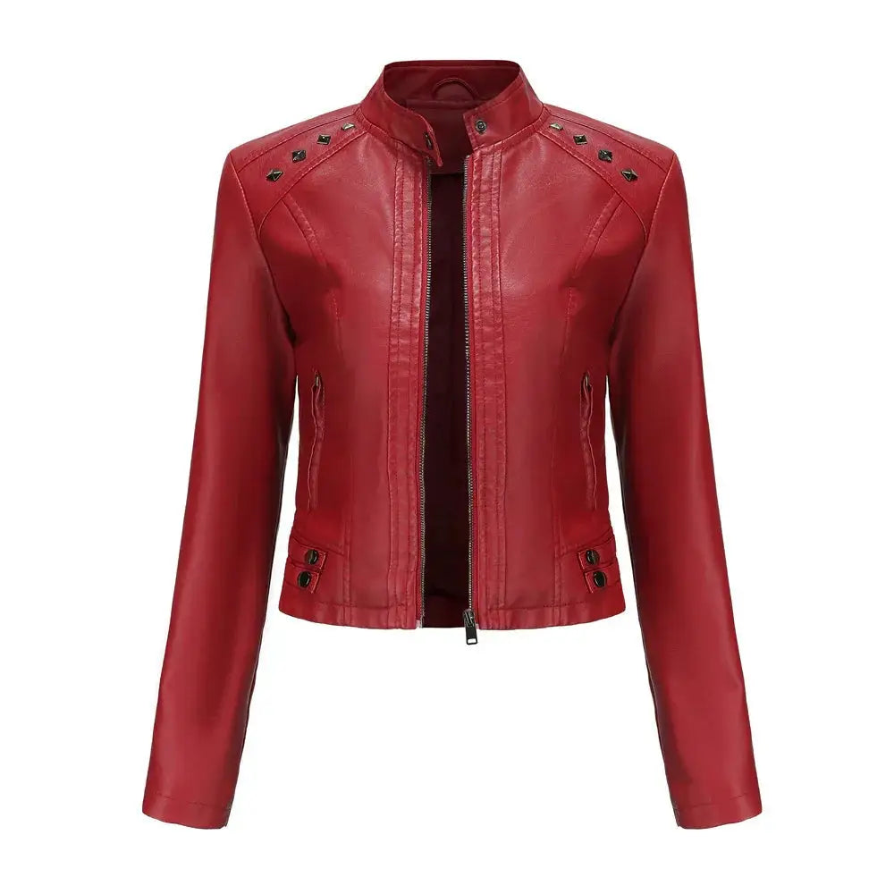 Red faux leather moto jacket with black studs along shoulders and front zipper featuring silver rivets