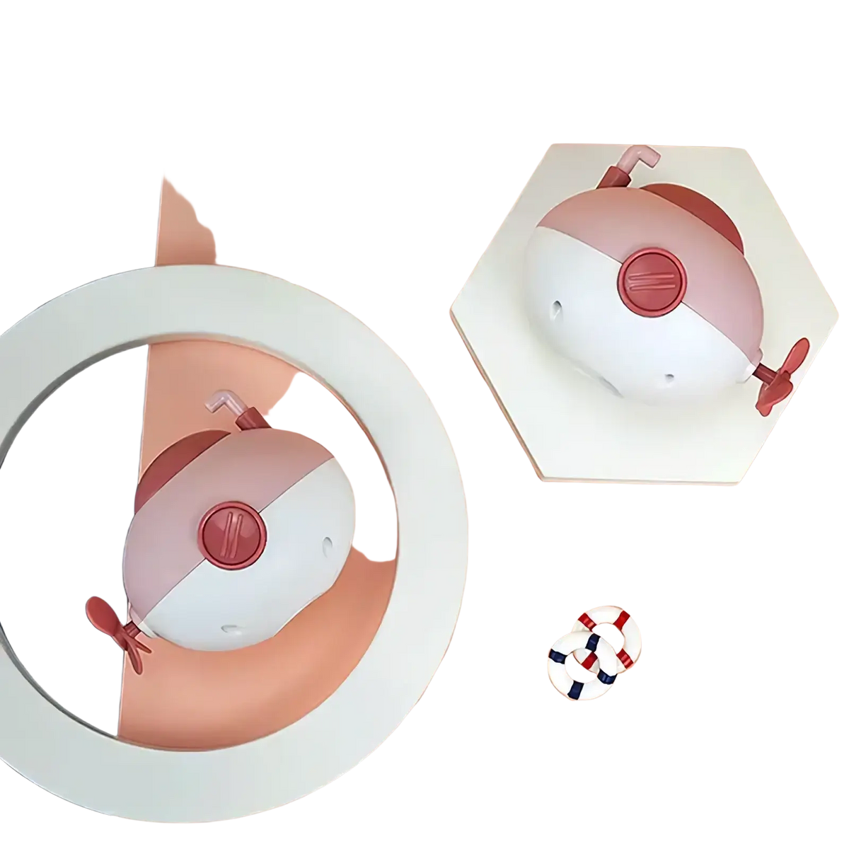 Submarine baby bath toy in pink and white with red accents featuring a central button and small propeller appendages