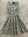 A sleeveless vintage 1950s mint green cotton a-line dress with a delicate pink yellow and brown floral pattern