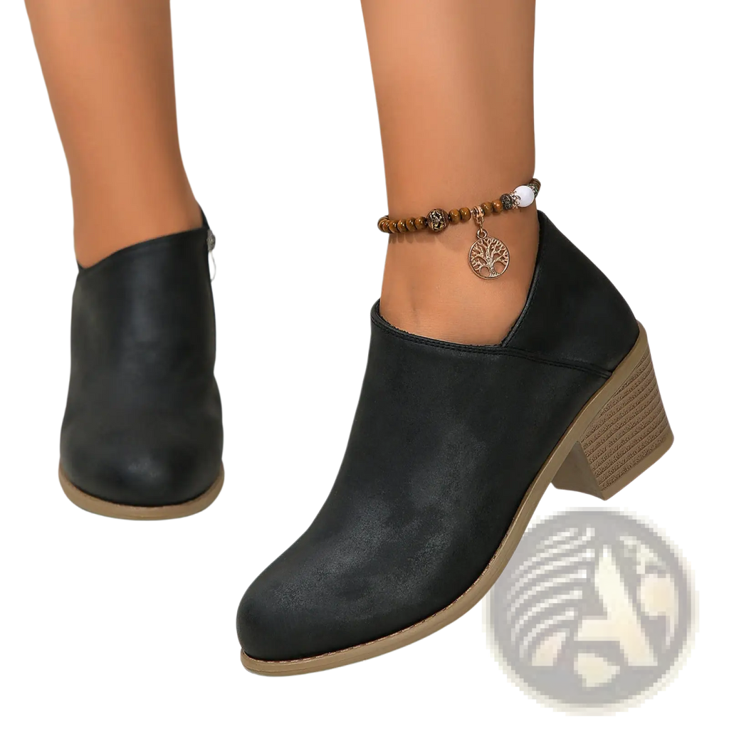 Black leather ankle boot with textured matte finish and light brown stacked chunky heel with side zipper visible