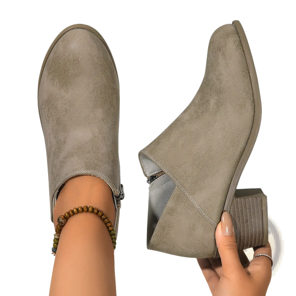 Gray suede ankle boot with chunky block heel and side zipper closure shown from the back side