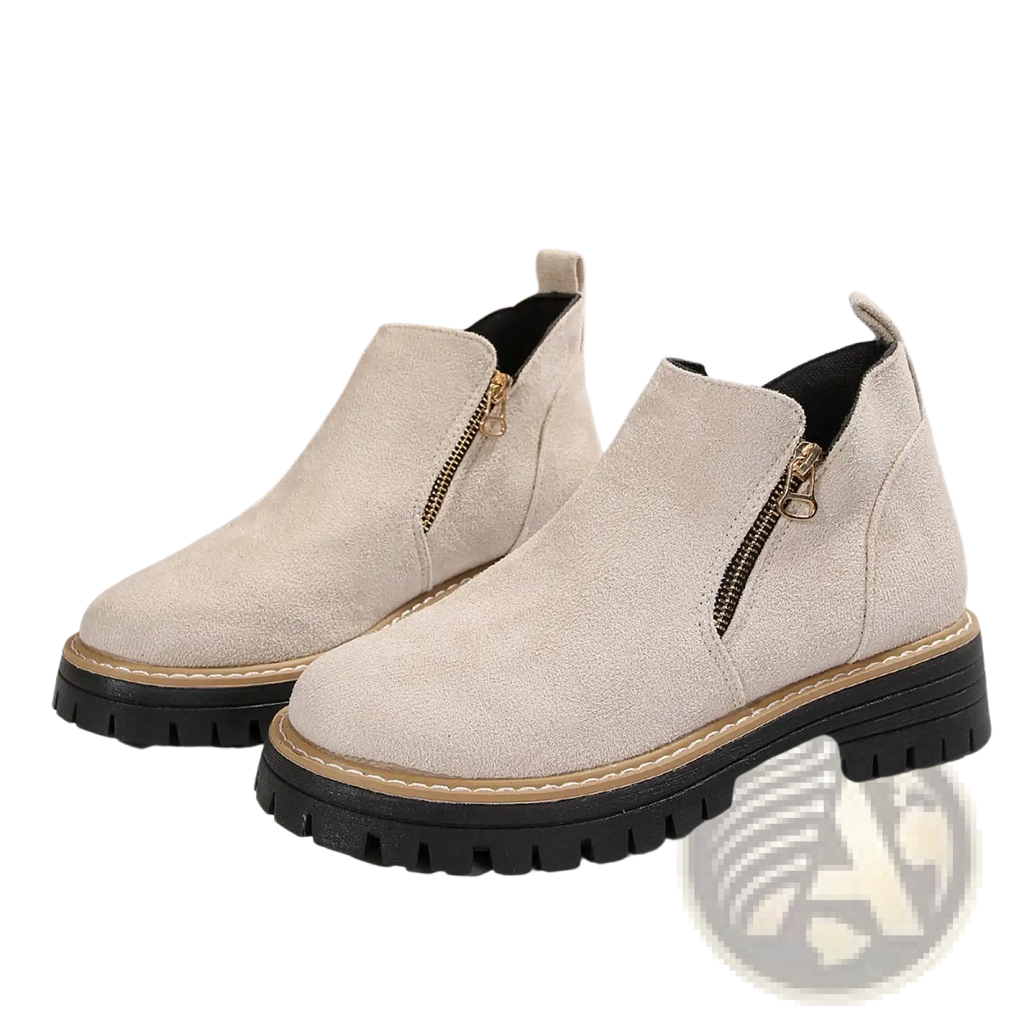 Beige suede ankle boots with chunky black rubber soles and gold side zippers for stylish casual wear