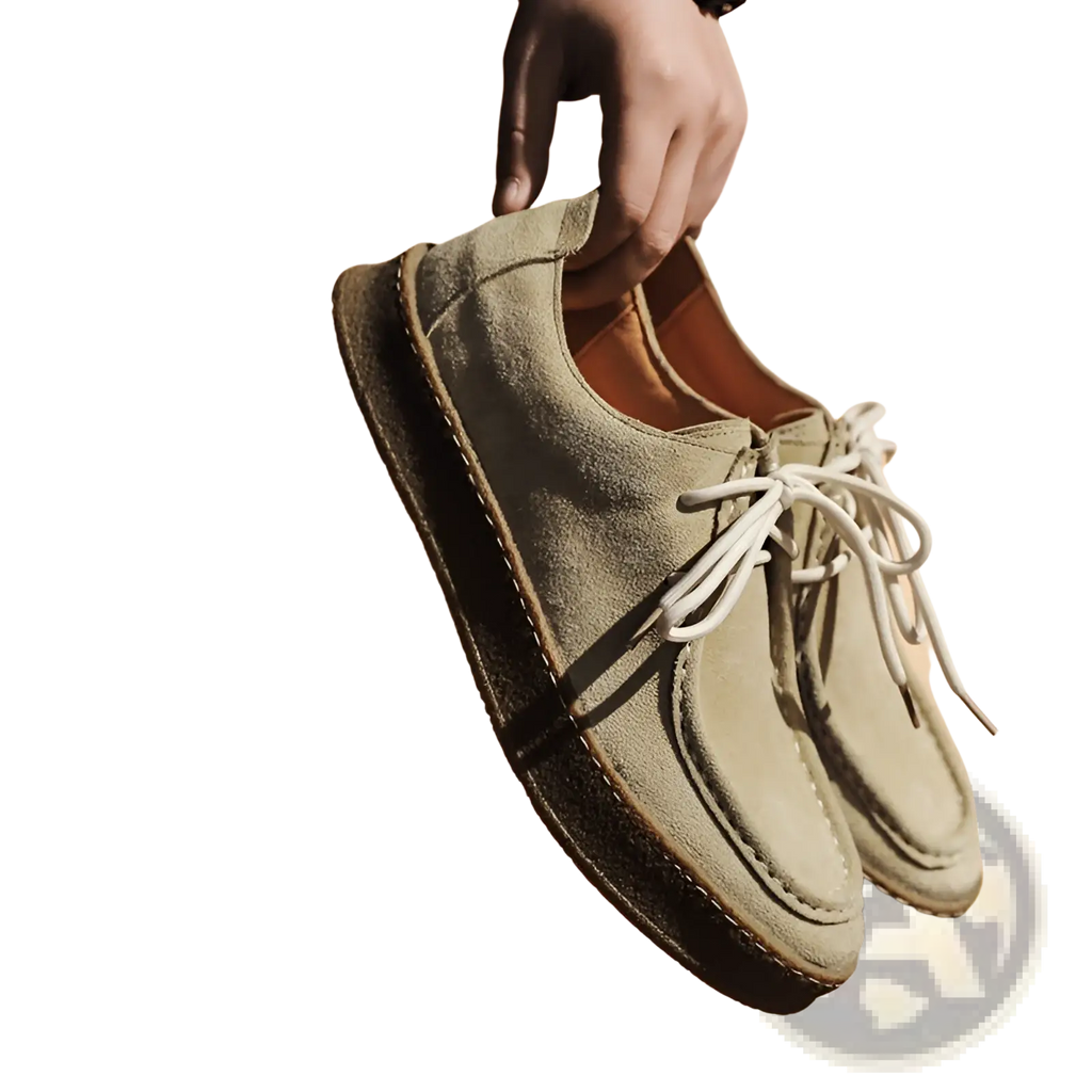 A pair of olive green suede british style casual lace up leather shoes with white laces and tan leather interior