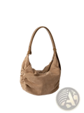 Tan suede dumpling shoulder bag with soft slouchy silhouette and matching leather handles for crossbody and hobo use
