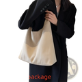 Cream-colored suede shoulder bag large capacity slouchy tote with minimalist canvas design and black button strap detailing