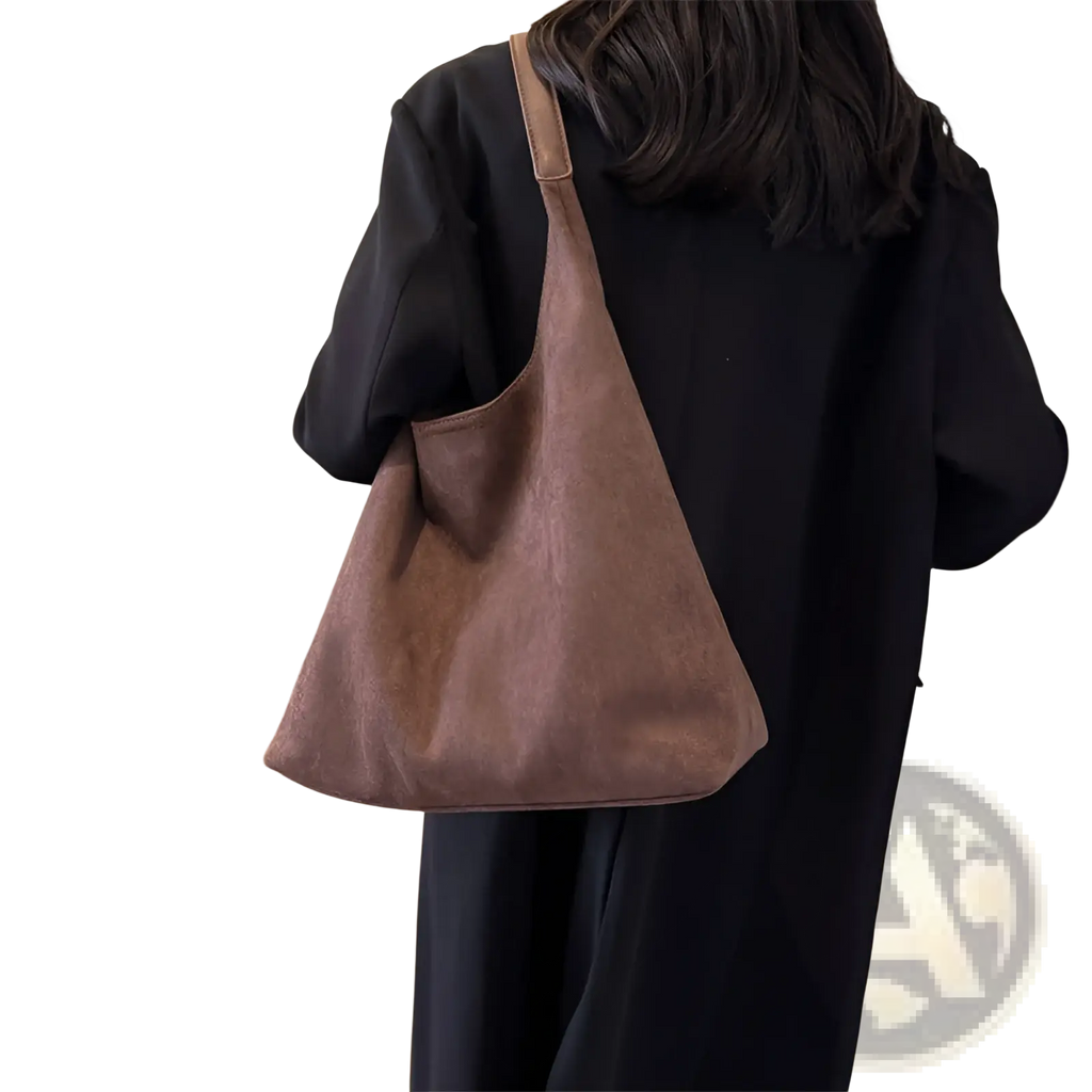 A soft muted brown suede shoulder bag with a single strap and minimalist design large capacity tote bag