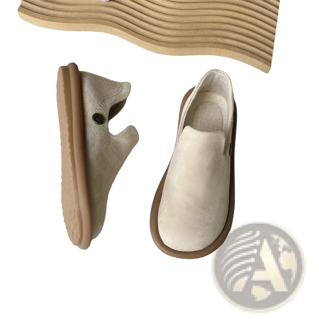 Beige suede slip on vintage British style low heel pumps with tan rubber sole and small black button detail on side