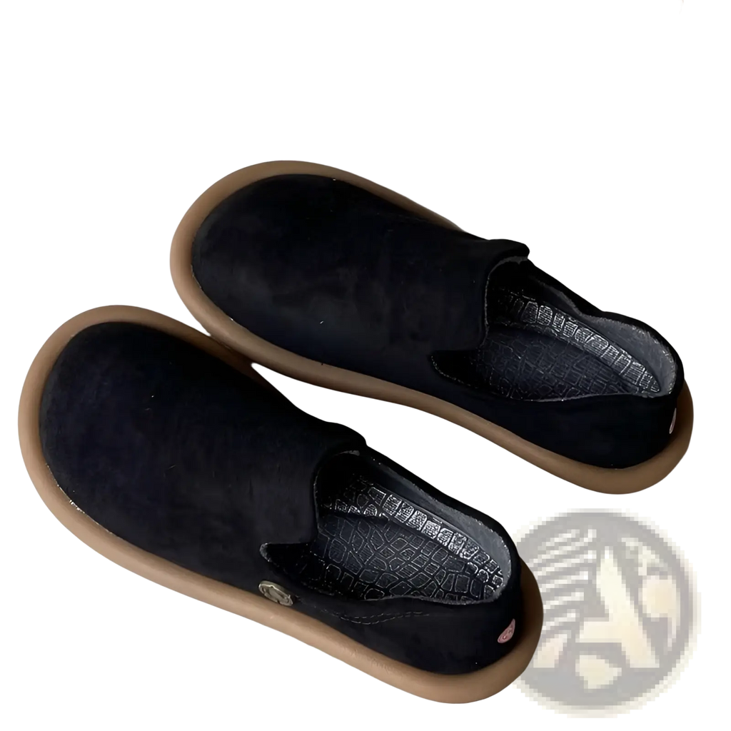 Black suede slip-on pumps with tan rubber sole and subtle branding detail in vintage british style low heel design
