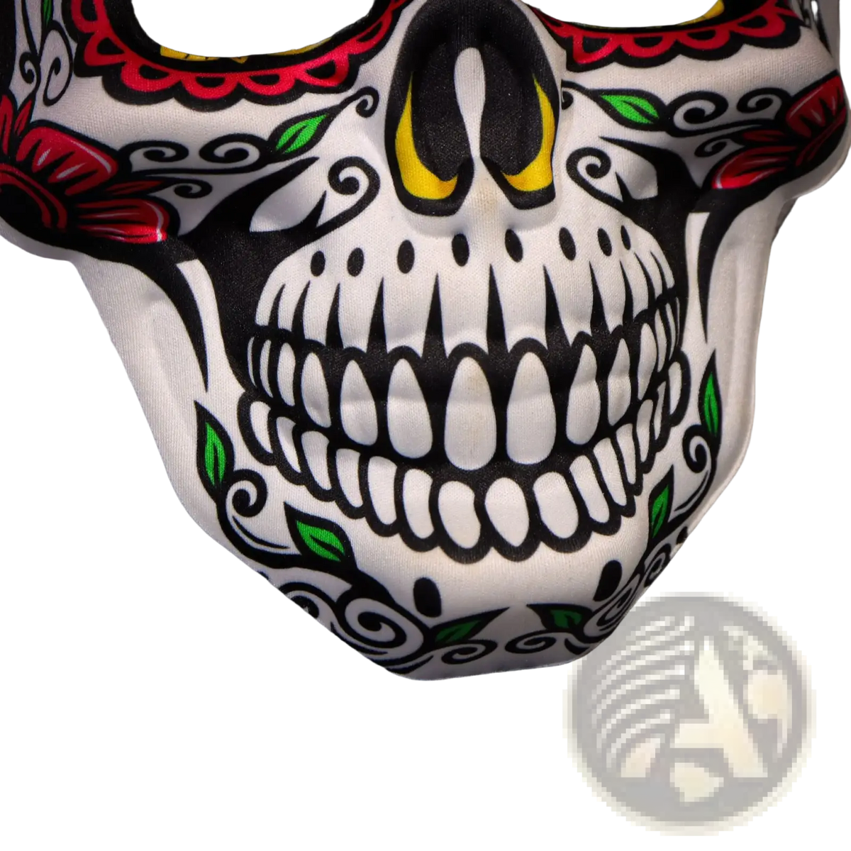 A white fabric sugar skull mask with vibrant red black and green floral patterns and yellow eye accents for Day of the Dead