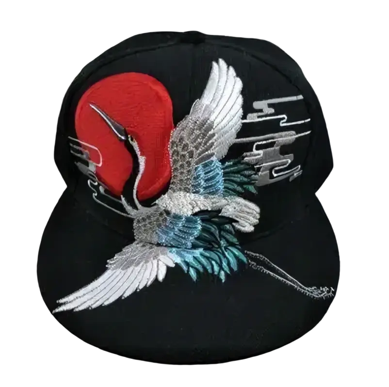 Black snapback cap featuring embroidered white and teal crane in flight with red circle and silver cloud motifs sugar skull rivet design