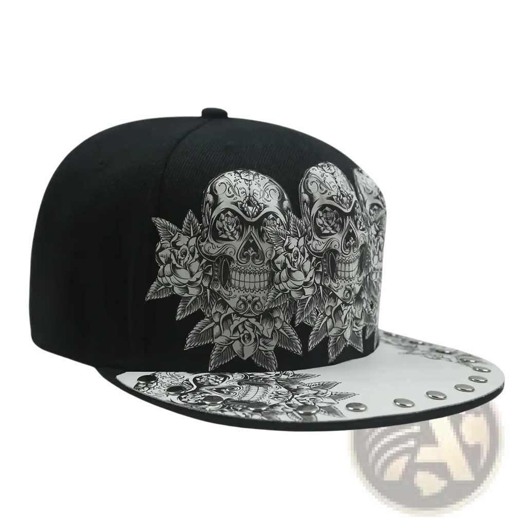 Black snapback baseball cap featuring intricate silver sugar skull and rose designs with white studded brim