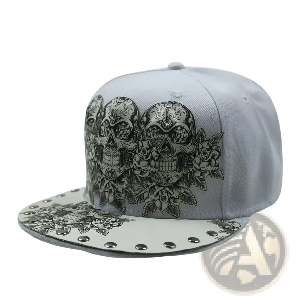 Gray snapback baseball cap with intricate black and white sugar skull floral designs and silver rivet accents on the brim