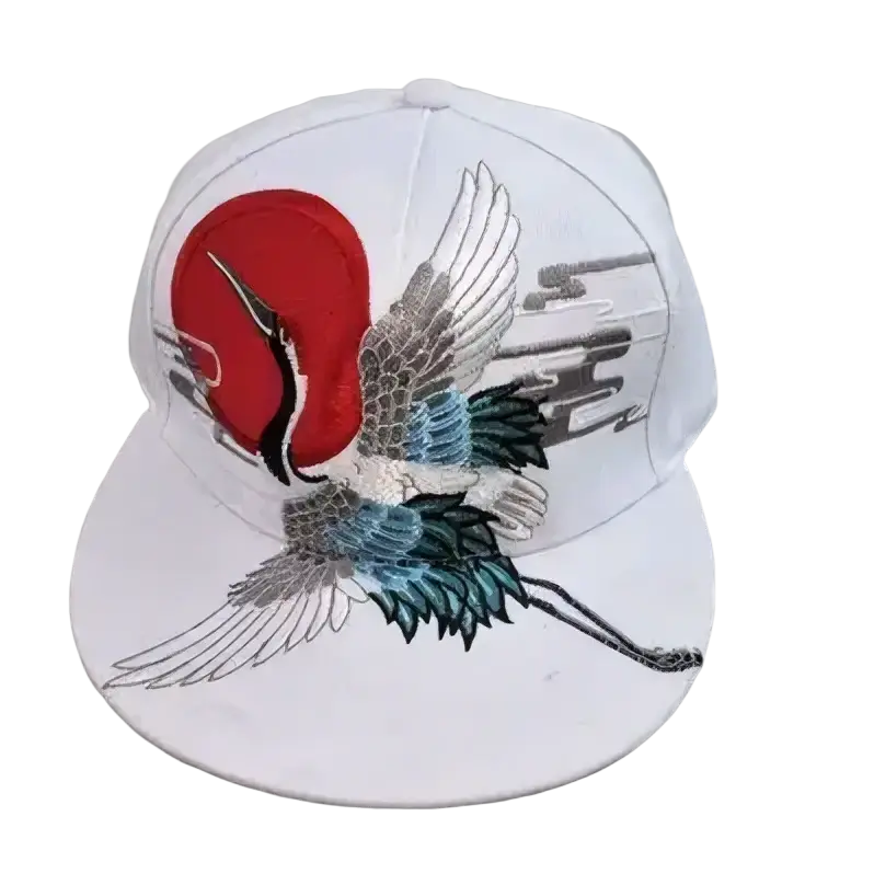 White sugar skull rivet snapback baseball cap with detailed embroidered crane in red blue and silver threadwork