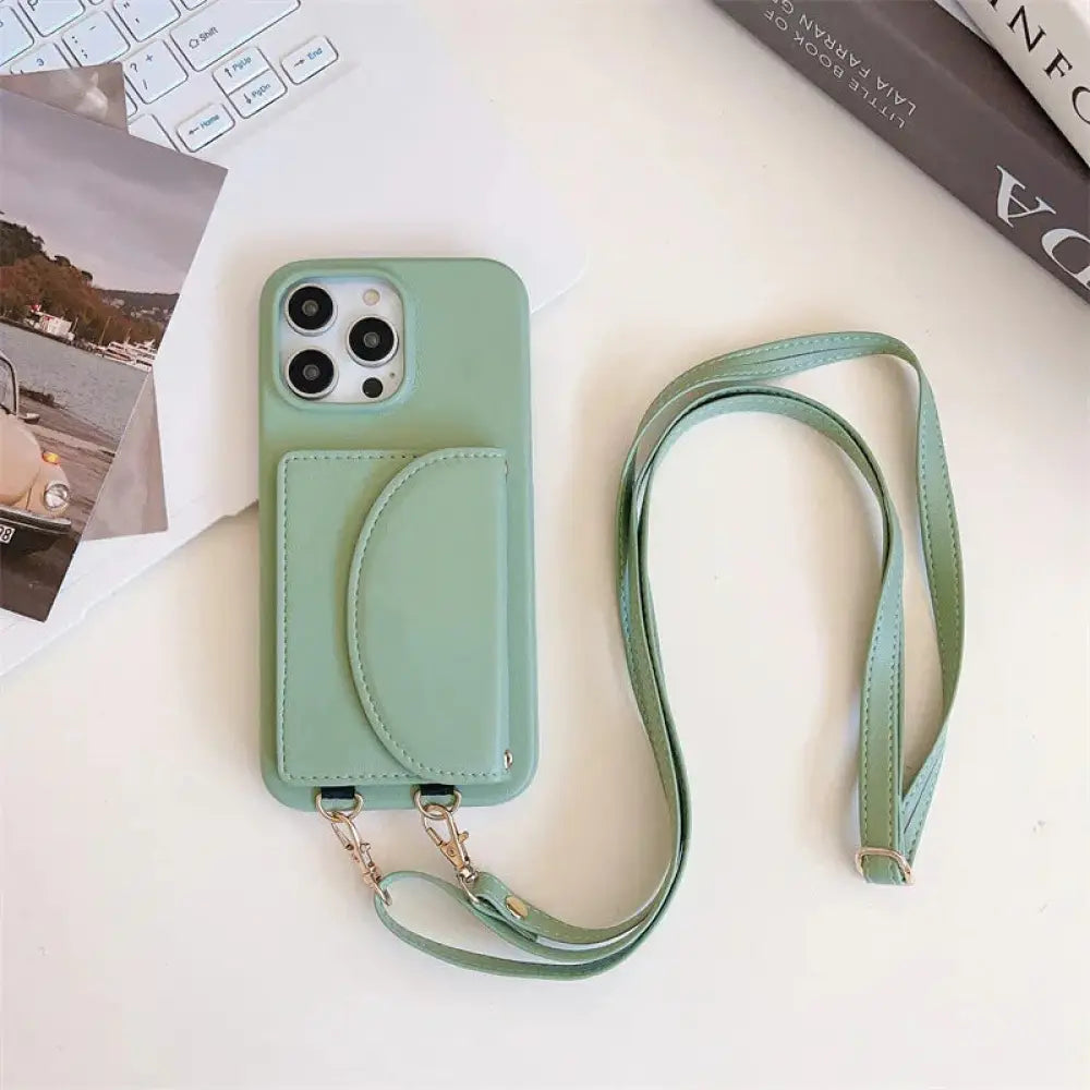 Mint green litchi leather card holder phone case with attached strap and card pocket shown from the back side