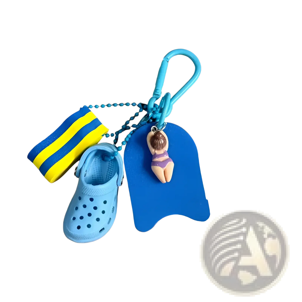 Blue miniature croc summer beach clog keychain with striped swim sock and buoy keychain featuring a woman figurine