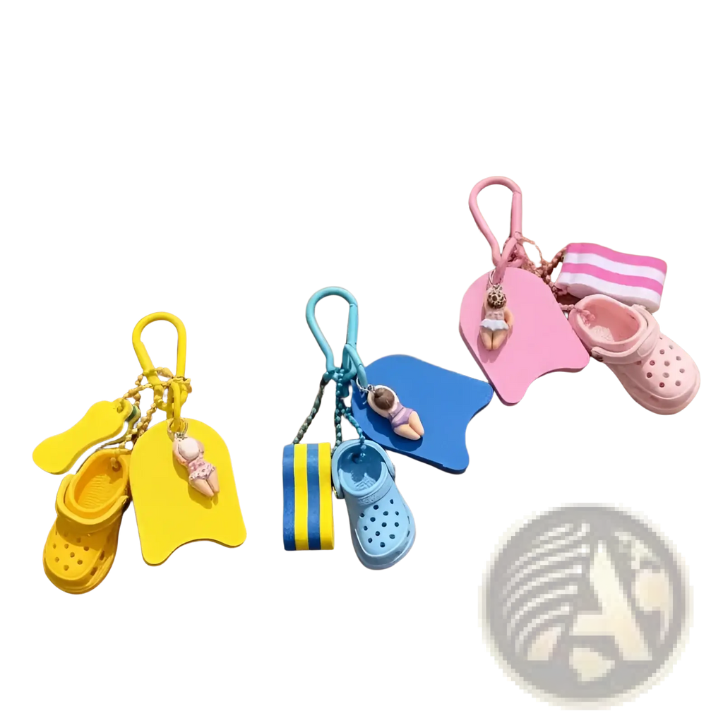 Three colorful summer beach clog keychains in yellow blue and pink featuring miniature swim floats and croc shoes