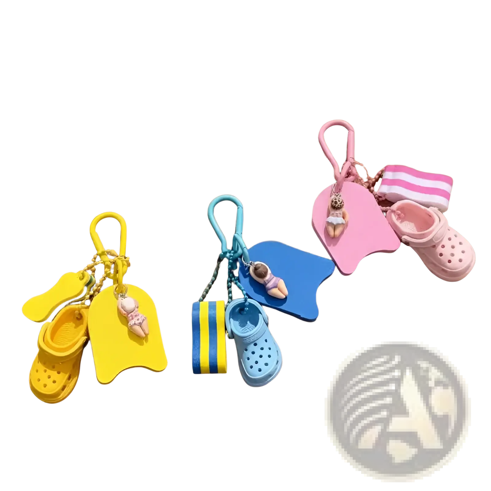 Three colorful summer beach clog keychains in yellow blue and pink featuring miniature swim floats and croc shoes