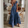 A flowing blue floral paisley maxi dress with v neckline and tiered skirt made from lightweight fabric