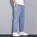 Men’s wide leg light wash denim joggers featuring a relaxed fit and rolled cuffs in light-wash denim