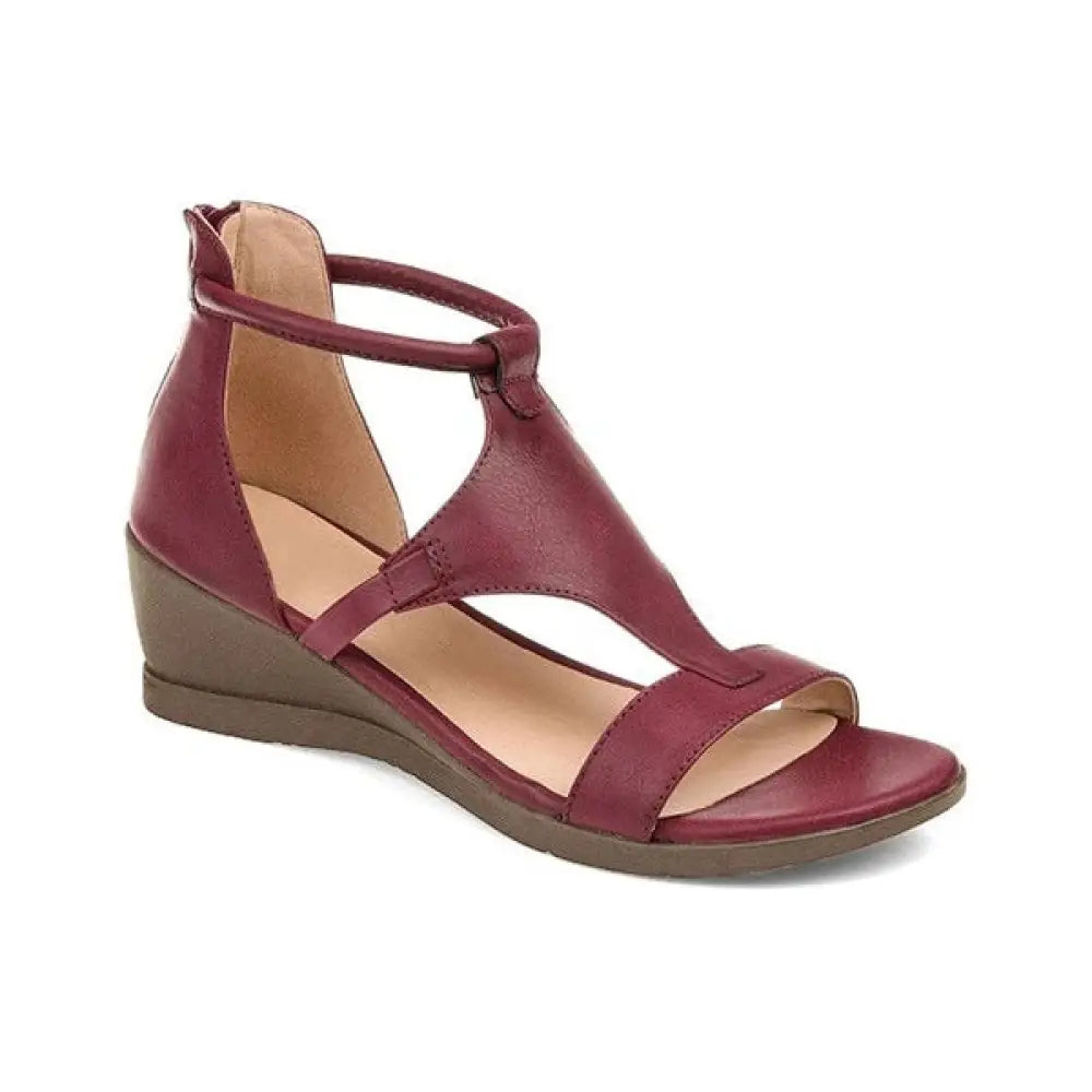Maroon leather wedge sandal with t-strap and ankle strap designed for women’s summer wear