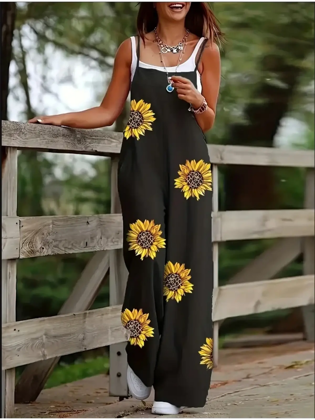 Black sunflower print wide leg summer jumpsuit with white straps and a relaxed fit for casual wear