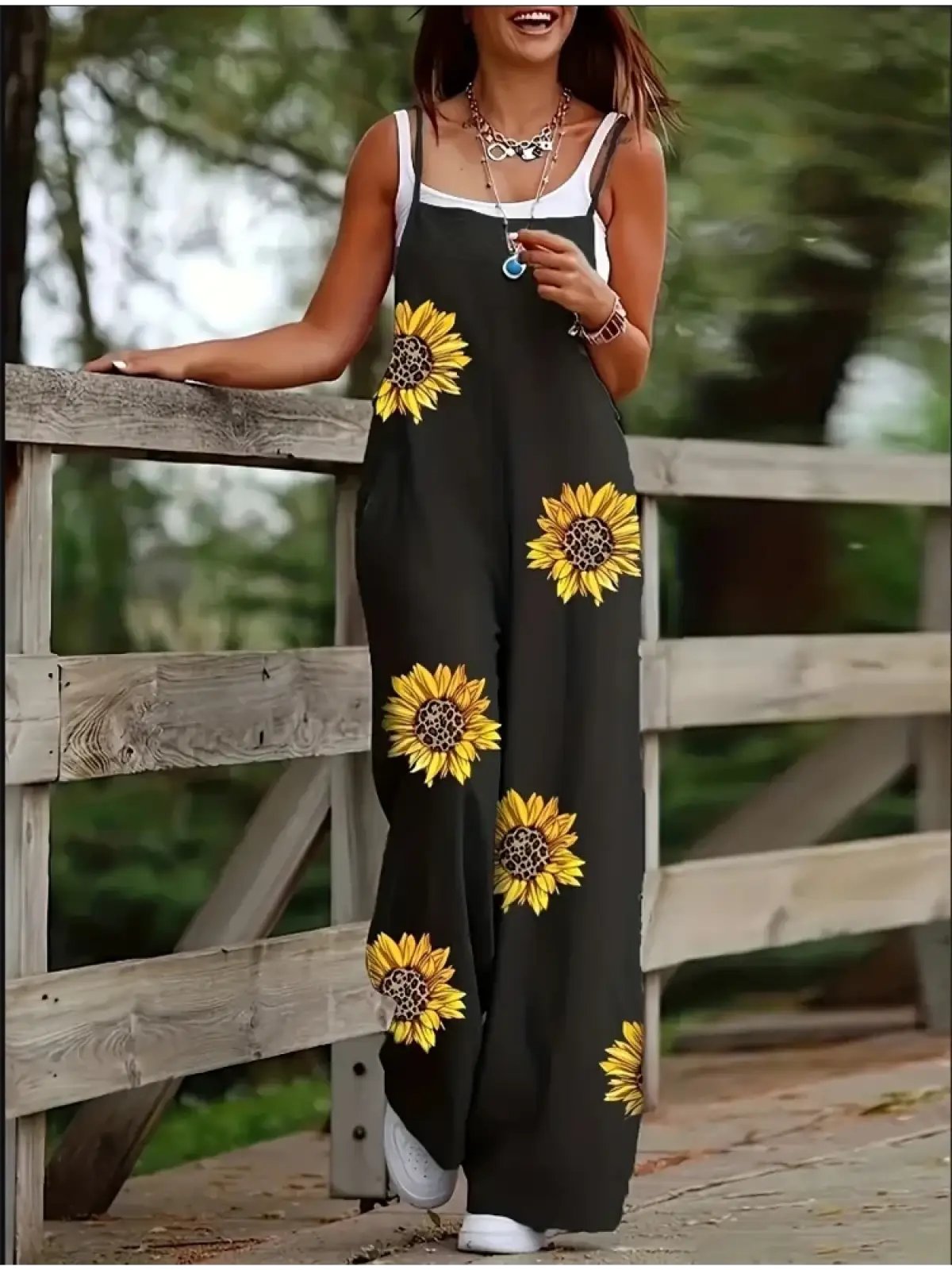 Black sunflower print wide leg summer jumpsuit with white straps and a relaxed fit for casual wear