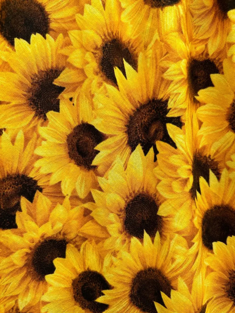 Vintage sunflower print 1950s cotton midi dress with pockets featuring bright yellow sunflowers on fabric surface
