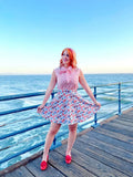Pink and white patterned sleeveless top with bow neckline paired with sunny days vintage phone print skater skirt